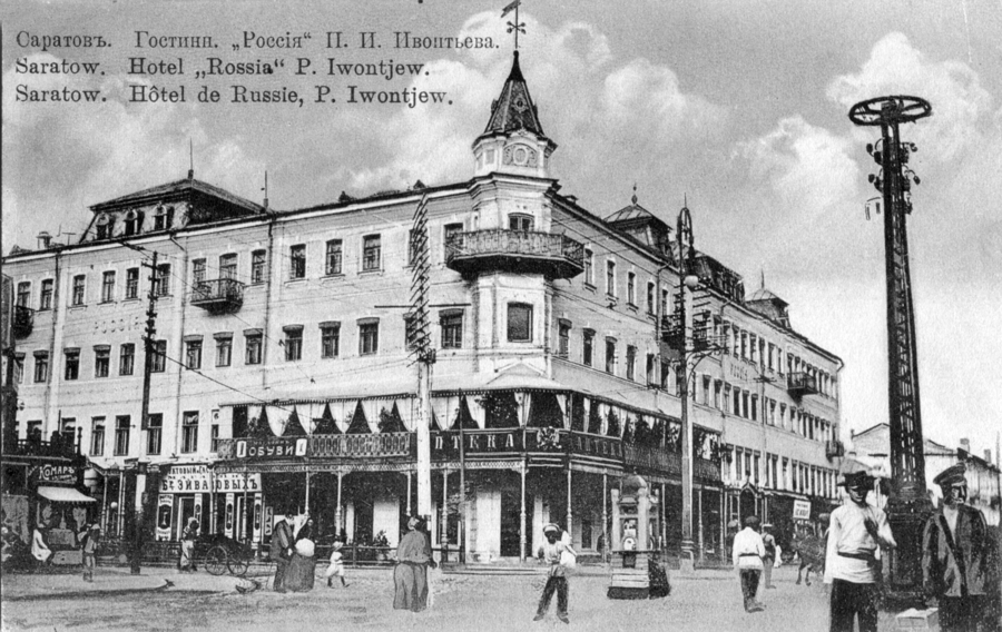 Гостиница «Россия» в Саратове, 1908 год. В 1888 году здание на пересечении Александровской (теперь улица Горького) и Немецкой улиц (теперь проспект Столыпина) перешло в руки наследнику крупного мукомольного предприятия Ивану Зейферту. Он решил перестроить его и открыть в нём отель европейского уровня. По проекту архитектора Франциска Шустера над угловой частью дома была надстроена башенка с флюгером и балкон на втором этаже, летом на него выносили столики ресторана при гостинице. На основании башенки и сейчас можно разглядеть переплетающиеся буквы «И» и «З» — инициалы Ивана Зейферта. В 1902 году в здании был надстроен четвёртый этаж, а также появились лифт, центральное отопление, электрическое освещение, телефонная связь. Гостиница состояла из 100 меблированных комнат, располагала рестораном с превосходной кухней и лучшими винами русских и заграничных фирм. В советские годы в здании располагались коммунальные квартиры, в 1995-м случился пожар, башенка сгорела. Сейчас здание постепенно ветшает. Фото wikimedia